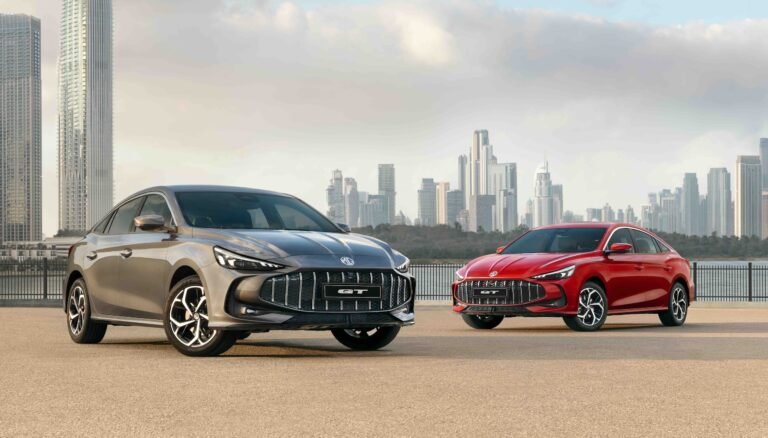 Fastback silhouette of the new MG GT in front of a Dubai landmark.