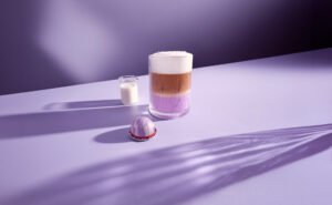 Colorful iced ube lavender latte made with new Nespresso decaf capsules in a Dubai home