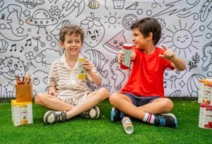 Children enjoying a creative session with kids hydration Dubai cans at a community center.