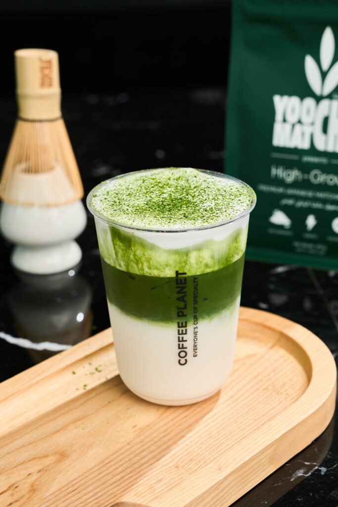 Vibrant layered iced drinks featuring matcha in Dubai at Coffee Planet outlets.