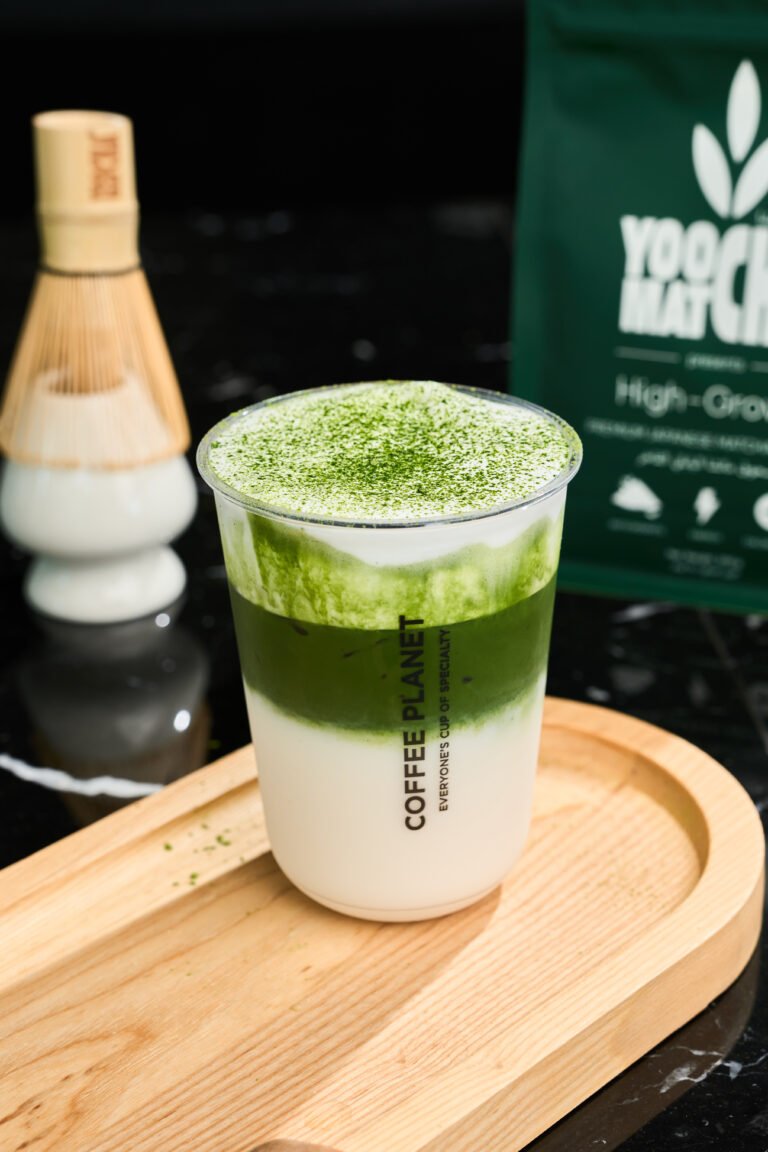 Vibrant layered iced drinks featuring matcha in Dubai at Coffee Planet outlets.