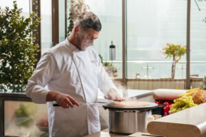 Chef preparing fresh treats at the live crêpe station Novikov Café breakfast Dubai Mall.