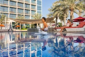 Happy family enjoying a beachfront Yas Island staycation in Abu Dhabi.